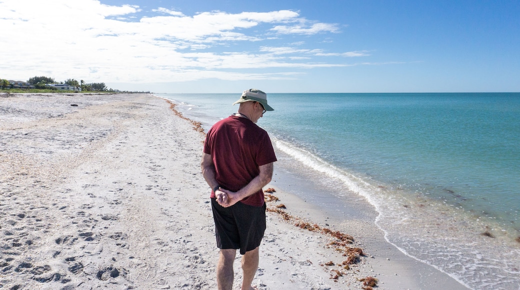 Retiree walks along tropical beach in Florida