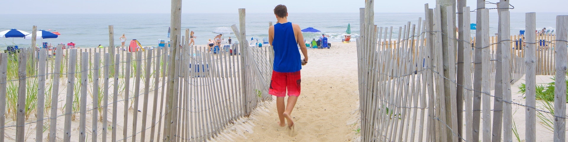 Atlantic City showing a sandy beach as well as an individual male