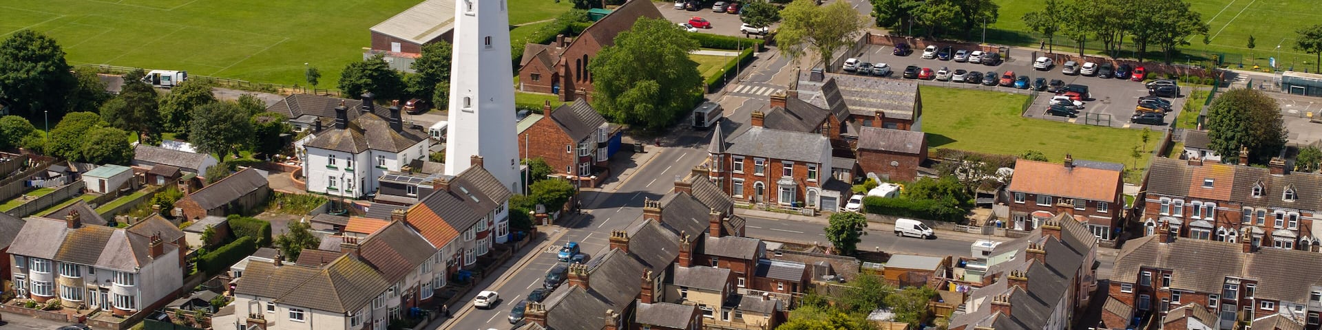 Aerial Withernsea UK.Withernsea is a seaside resort town and civil parish in Holderness, East Riding of Yorkshire, England. Its white inland lighthouse, rising around 127 feet (39 m)
