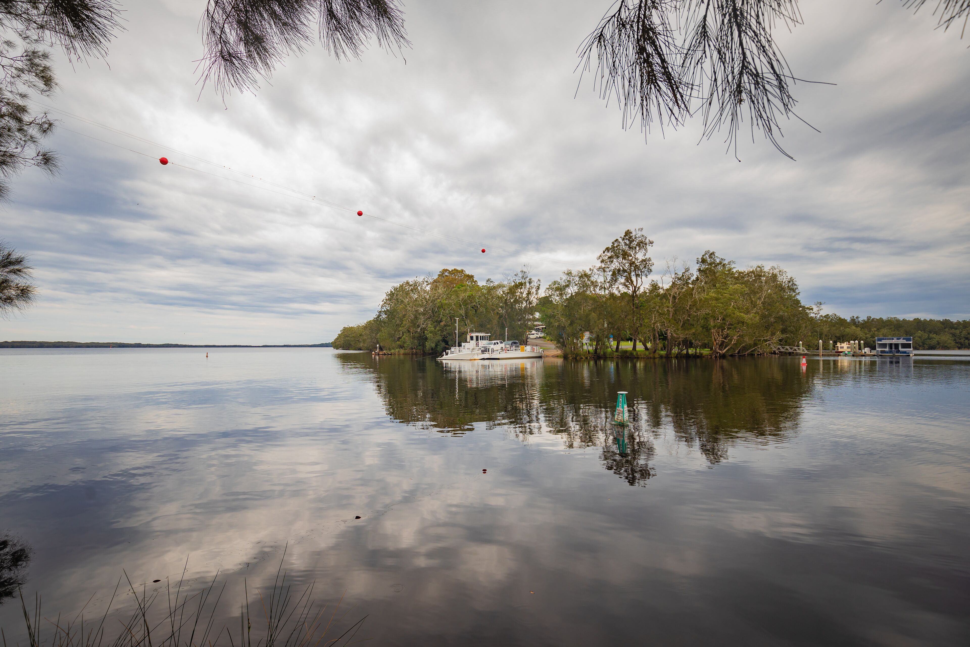 The Bombah Point Ferry carrying a vehicle across water