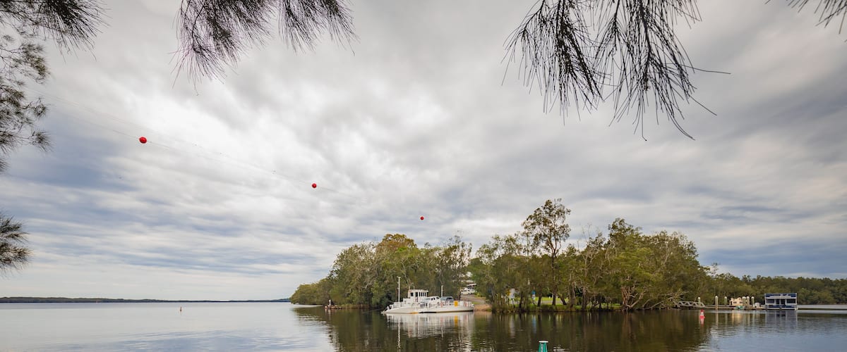 The Bombah Point Ferry carrying a vehicle across water