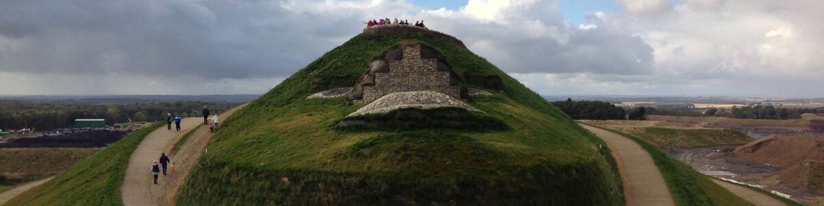The face of the Northumberlandia land form sculpture, showing her lips, the underside of her nose, eyes and forehead.