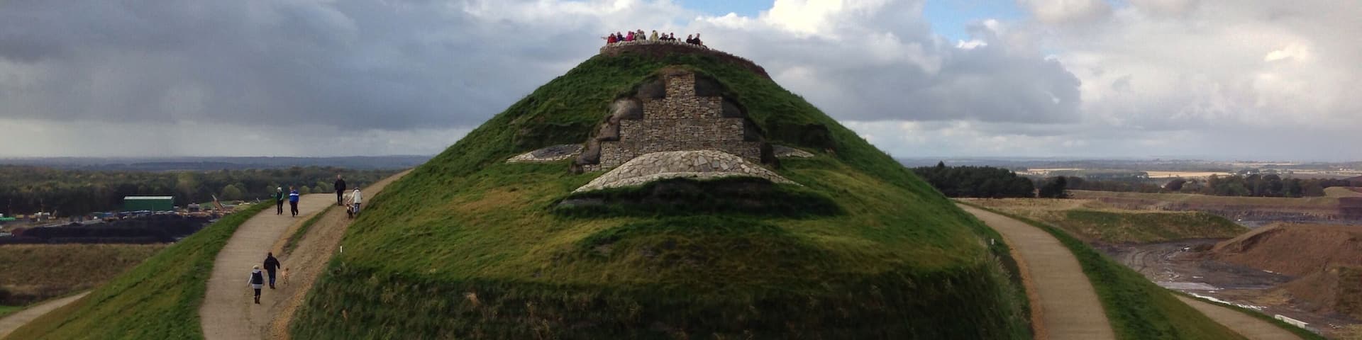The face of the Northumberlandia land form sculpture, showing her lips, the underside of her nose, eyes and forehead.