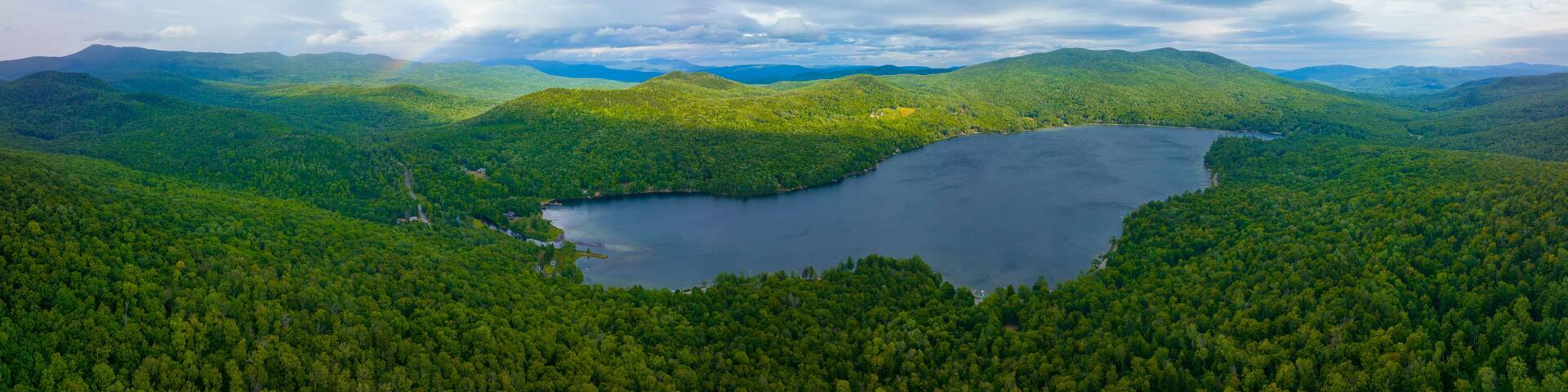 Aerial view of Rainbow over Stinson Lake in White Mountain National Forest in summer in town of Rumney, Grafton County, New Hampshire NH, USA.