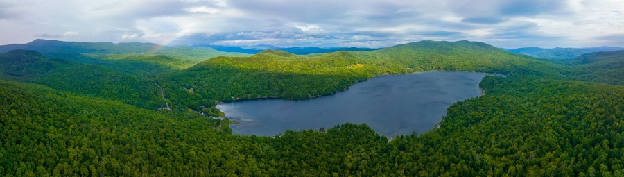 Aerial view of Rainbow over Stinson Lake in White Mountain National Forest in summer in town of Rumney, Grafton County, New Hampshire NH, USA.