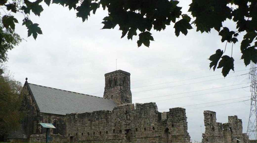 Jarrow, Tyne and Wear. The surviving wall of the west range of St Paul's Monastery, with St Paul's parish church beyond.