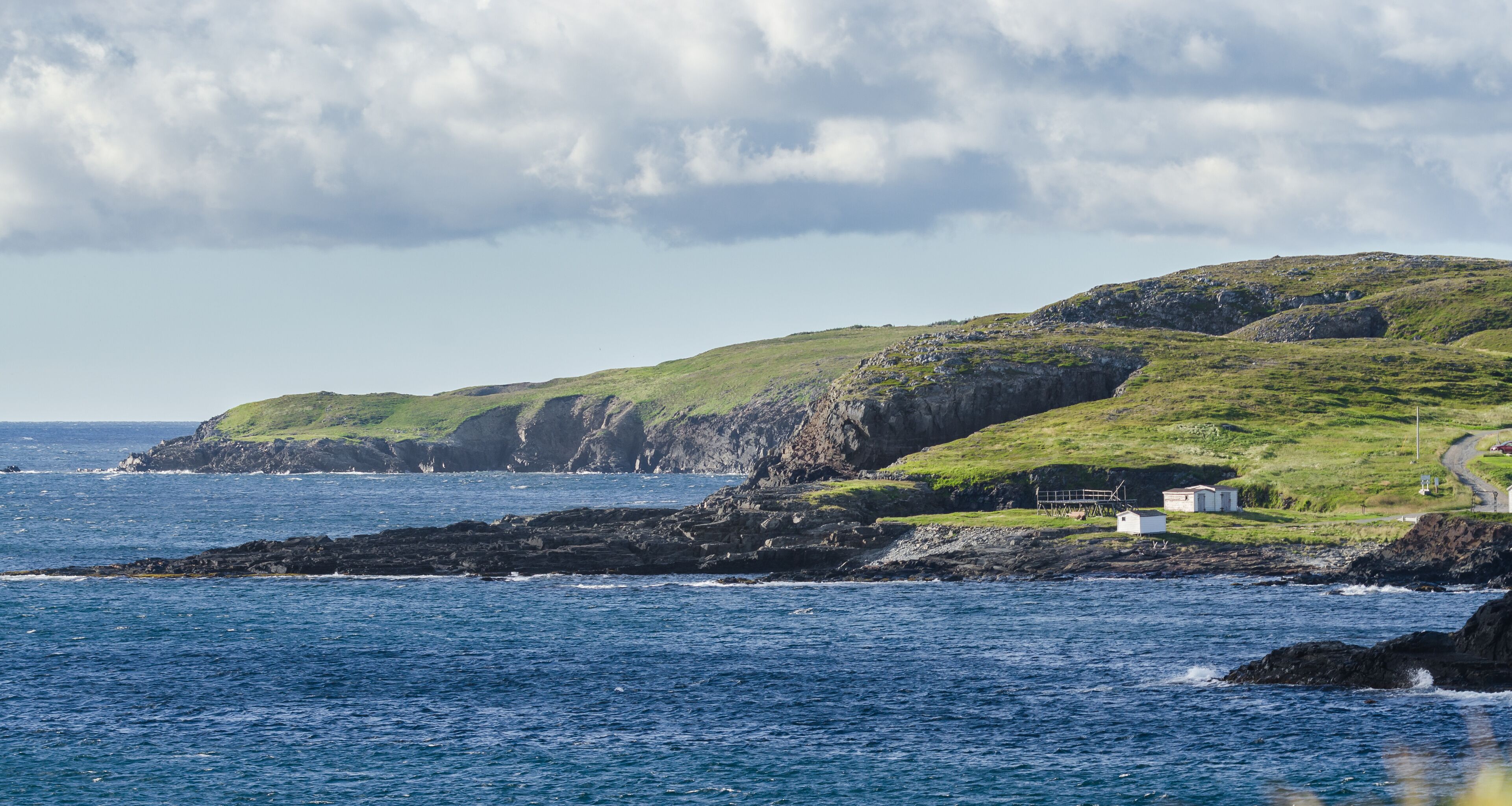 Ellistion cliffs, hillsides and shoreline.   Rocky coastline in Elliston village along the coast fingers of the Island of Newfoundland, Canada.
