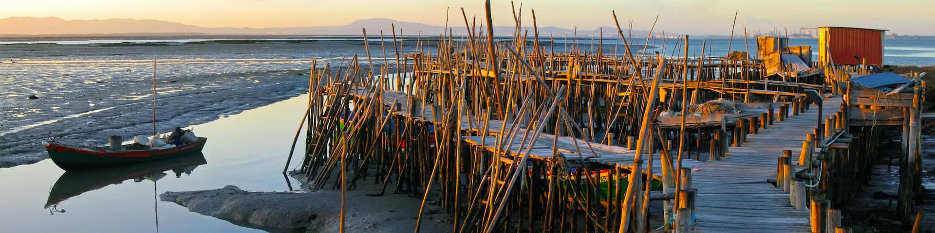 Traditional fishermen wooden jetties. Stilt piers or Cais Palafitico by the Sado River estuary during low tide on Carrasqueira, Alcacer do Sal, Setubal, Portugal