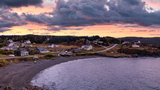 Panoramic view of a small town on the Atlantic Ocean Coast. Colorful Sunset Sky Art Render. Taken in Little Wild Cove, North Twillingate Island, Newfoundland and Labrador, Canada.