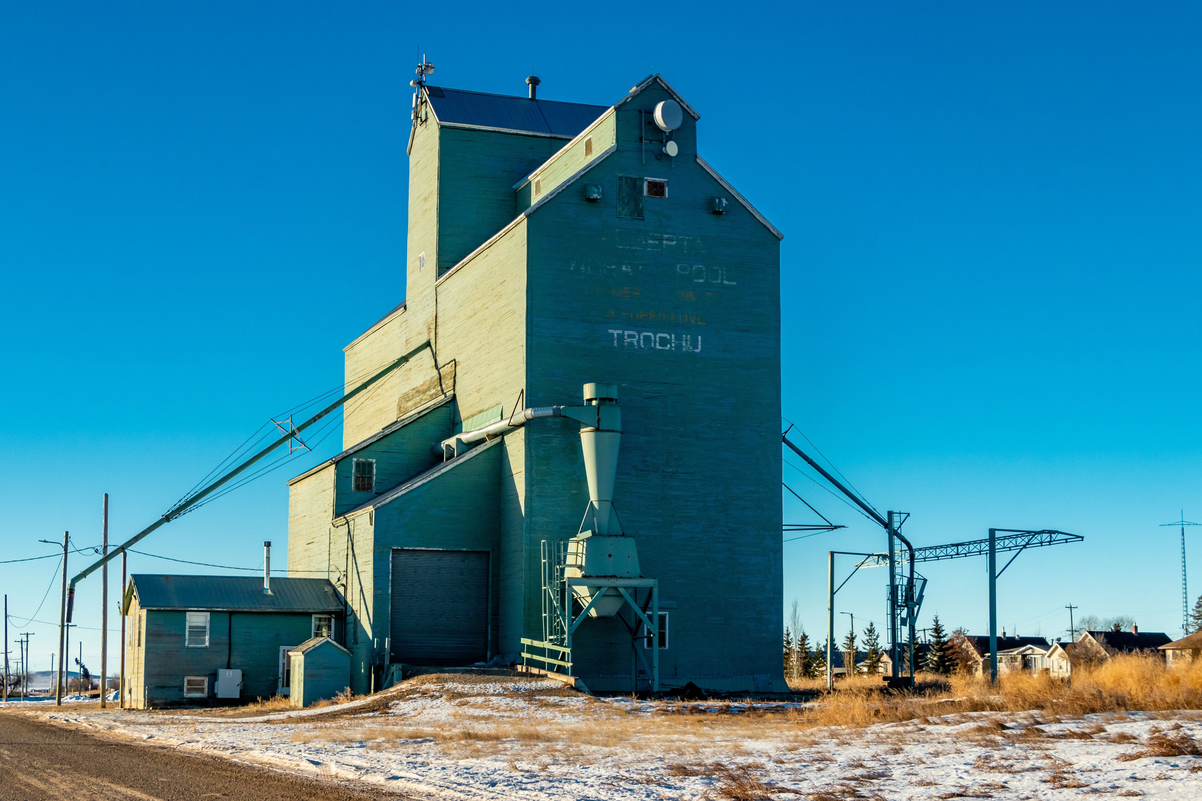 A large industrial building with a silo labeled "TROCHJ" and a smaller adjacent structure.