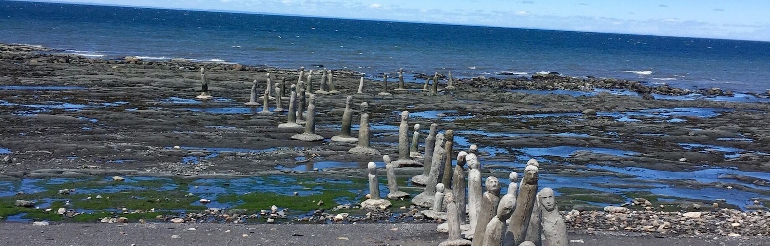 Sculptures by Marcel Gagnon at low tide.