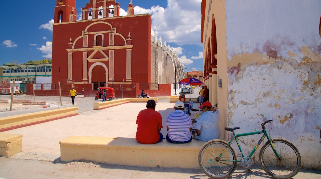 Seybaplaya featuring a church or cathedral as well as a small group of people
