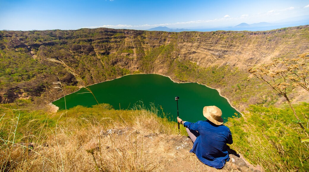Tourist at the top of the "Cosigüina" Volcano Natural Reserve. Chinandega, Nicaragua. Volcanic lagoon at the top of the volcano. Ancient eruption. Adventure tourism. Summer days in Central America.