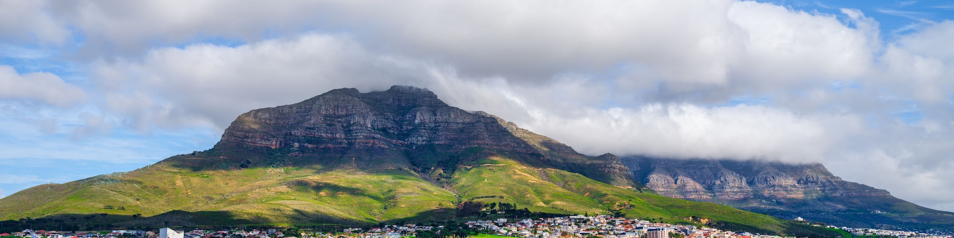 Cloud-covered Table Mountain and Devil's Peak over Woodstock houses, Cape Town, South Africa