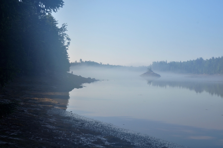 Lone Man Standing Over Misty Maine Ocean Inlet
