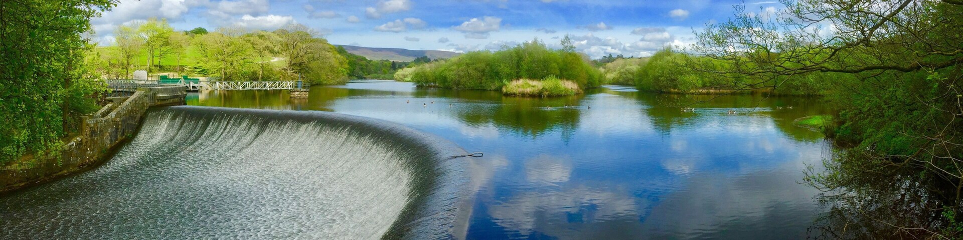 The River Wyre at Abbeystead. Park at Stoops Bridge to walk through woodland and around the reservoir to the dam.