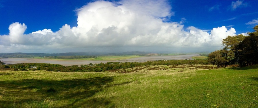 Looking over the Kent estuary towards a rainy Lake District from a sunny Arnside Knott.