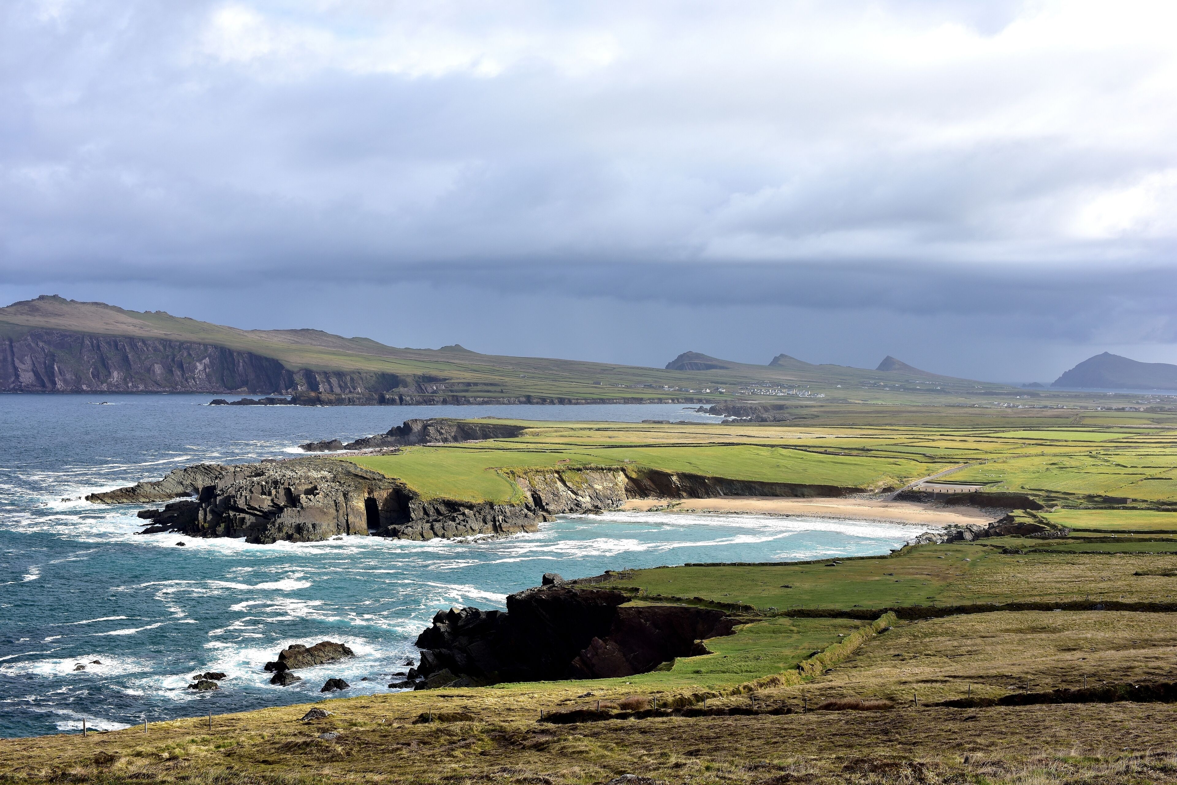 Clogher Head Car Park , Dingle Peninsula , Ireland

The view of Clogher Strand Beach and Three Sisters (group of three peaks) from Clogher Head Car Park.