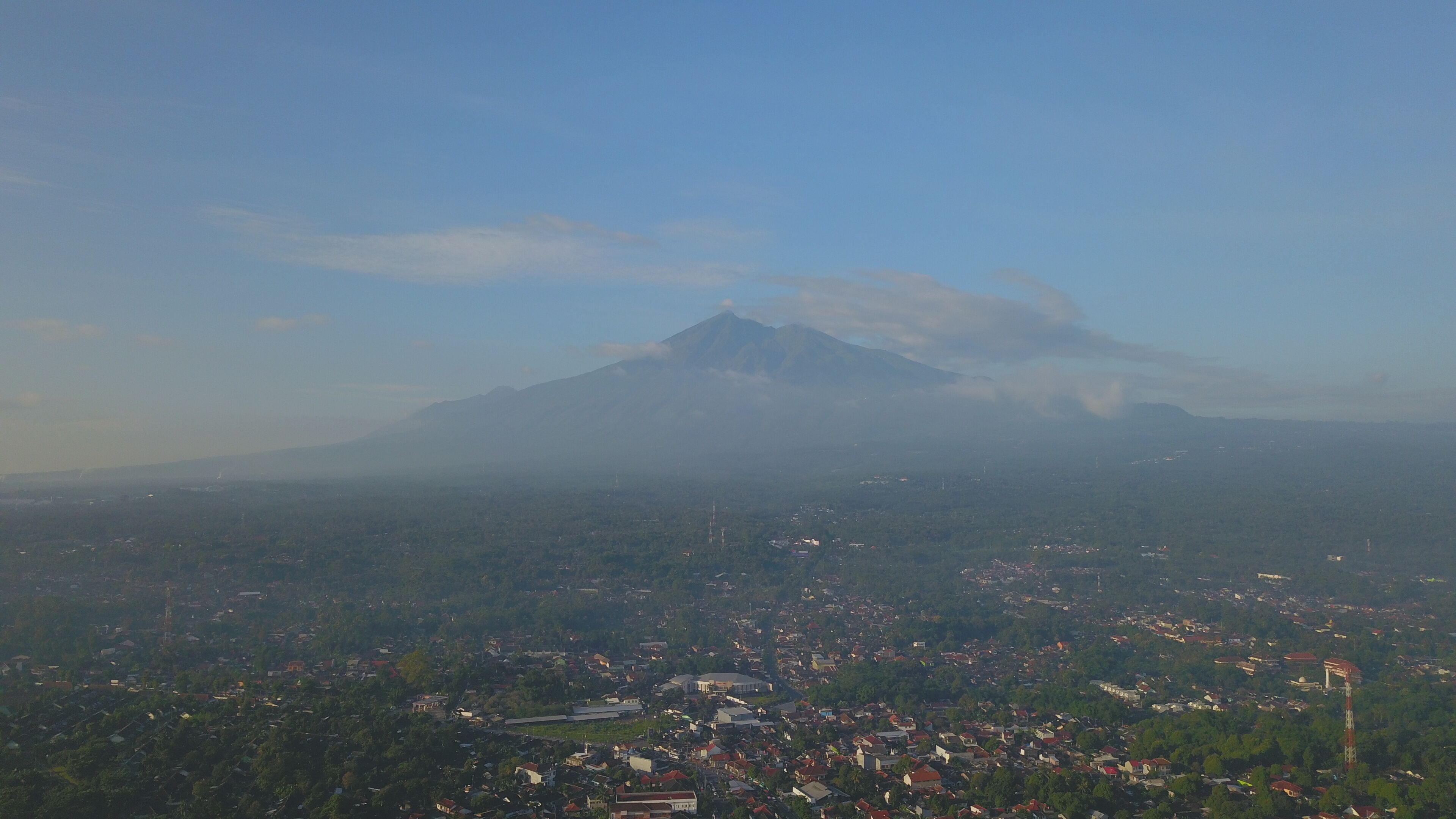 A mountain with a town in the foreground.