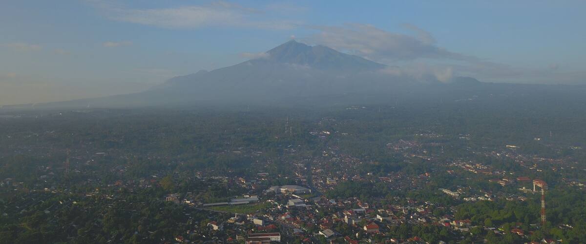 A mountain with a town in the foreground.
