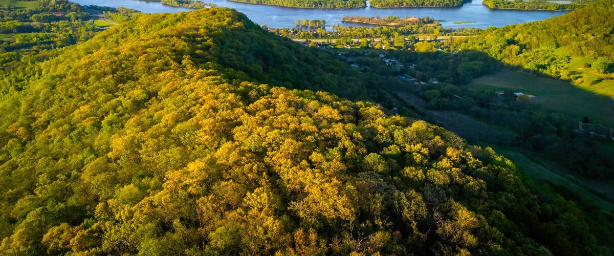 Aerial view from Apple Blossom Overlook Park showing green rolling hills and the Mississippi River