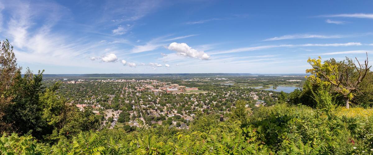 A town surrounded by greenery and a lake.