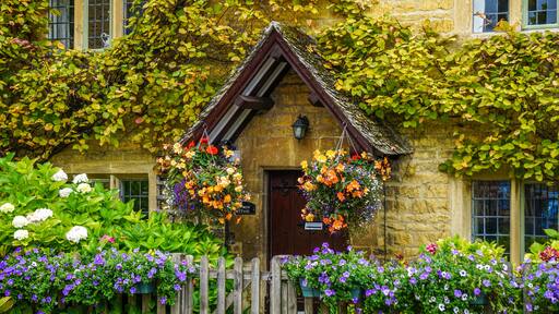Flower covered house in Bourton-on-the-Water in the Cotswolds, England