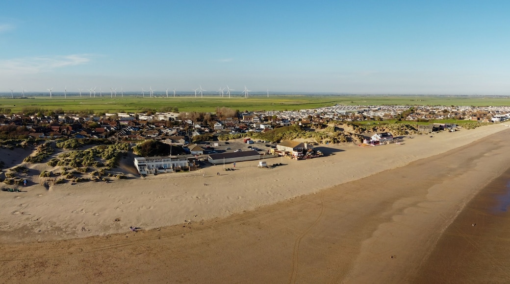 Aerial drone. Camber Sands in East Sussex. Popular seaside destination with large sandy beach and surfing spot in England.