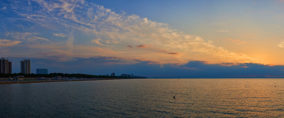 Amazing Sunset on the Sea. Adriatic sea, beautiful sunset, waves and landscape. Lignano Sabbiadoro, Italy.