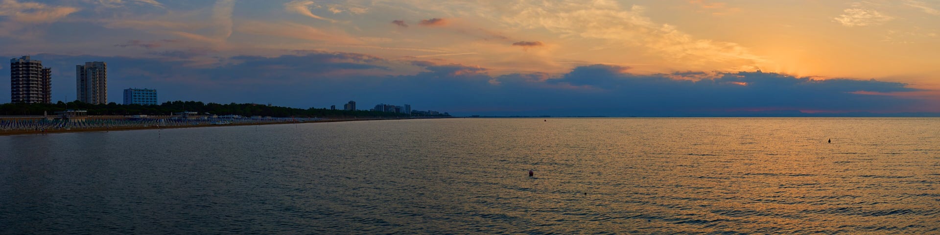 Amazing Sunset on the Sea. Adriatic sea, beautiful sunset, waves and landscape. Lignano Sabbiadoro, Italy.