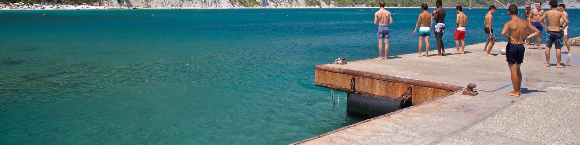 Portonovo featuring general coastal views as well as a small group of people