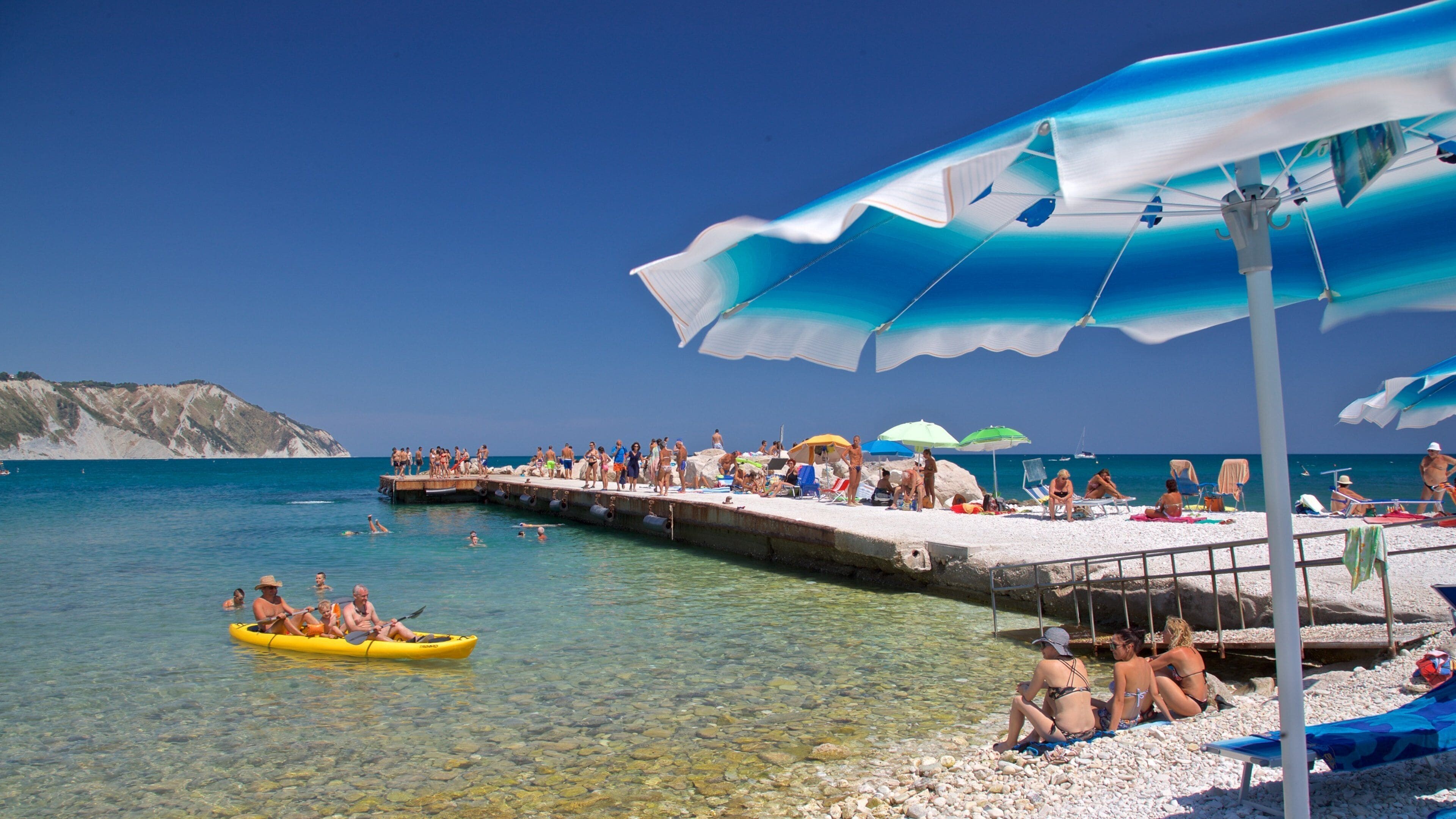 Portonovo showing kayaking or canoeing, general coastal views and a pebble beach
