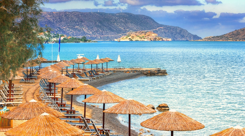 Panoramic view of the gulf of Elounda with the famous village of Elounda and the island of Spinalonga at sunset with nice clouds and calm sea, Crete, Greece.
