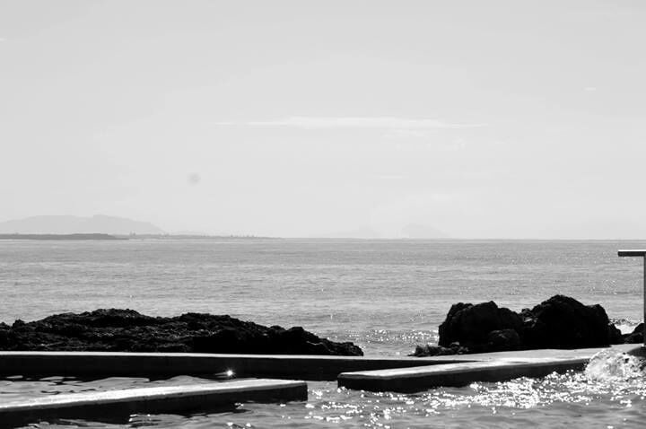 Shallow and deep ocean pools surrounded by the black rock pools.