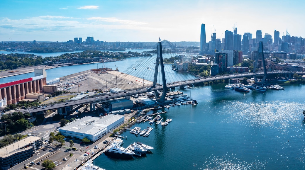 Aerial drone view of Anzac Bridge looking toward Sydney Harbour on a sunny morning