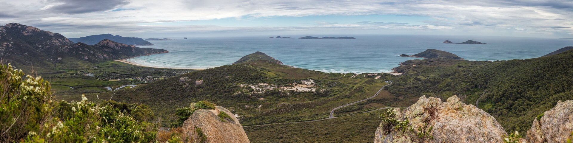 Looking out from the summit of Mount Bishop across the landscape and coastline around Tidal River in Wilsons Promontory national park, Victoria, Australia