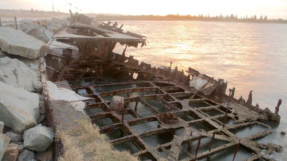 Newcastle showing a bay or harbour, a sunset and general coastal views