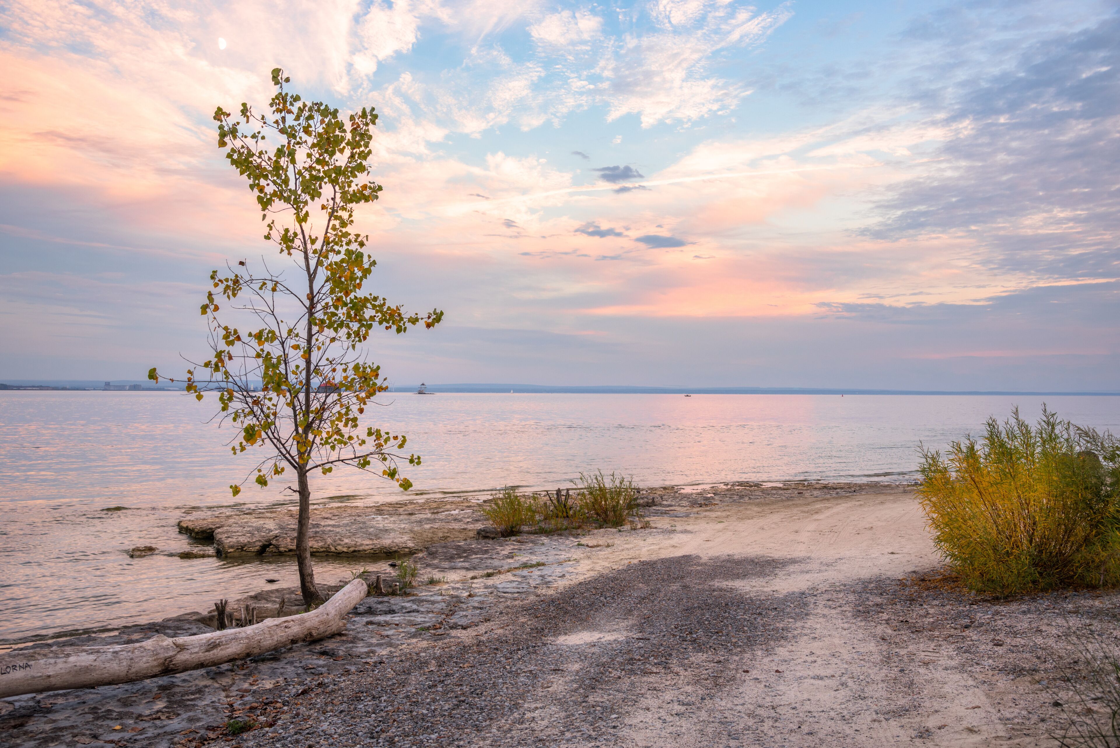 Majestic autumn sunset over an empty beach alog the shores of a lake in autumn. Lake Erie, Canada.