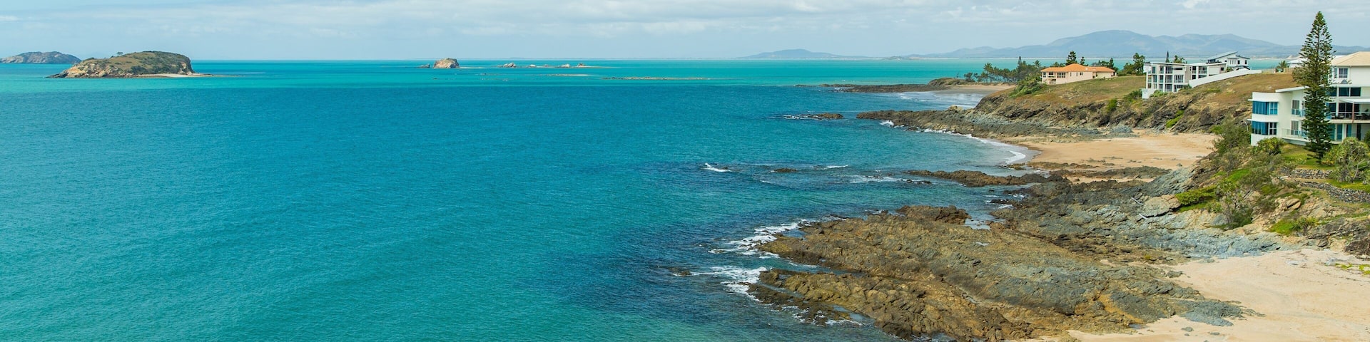Emu Park which includes general coastal views and rocky coastline