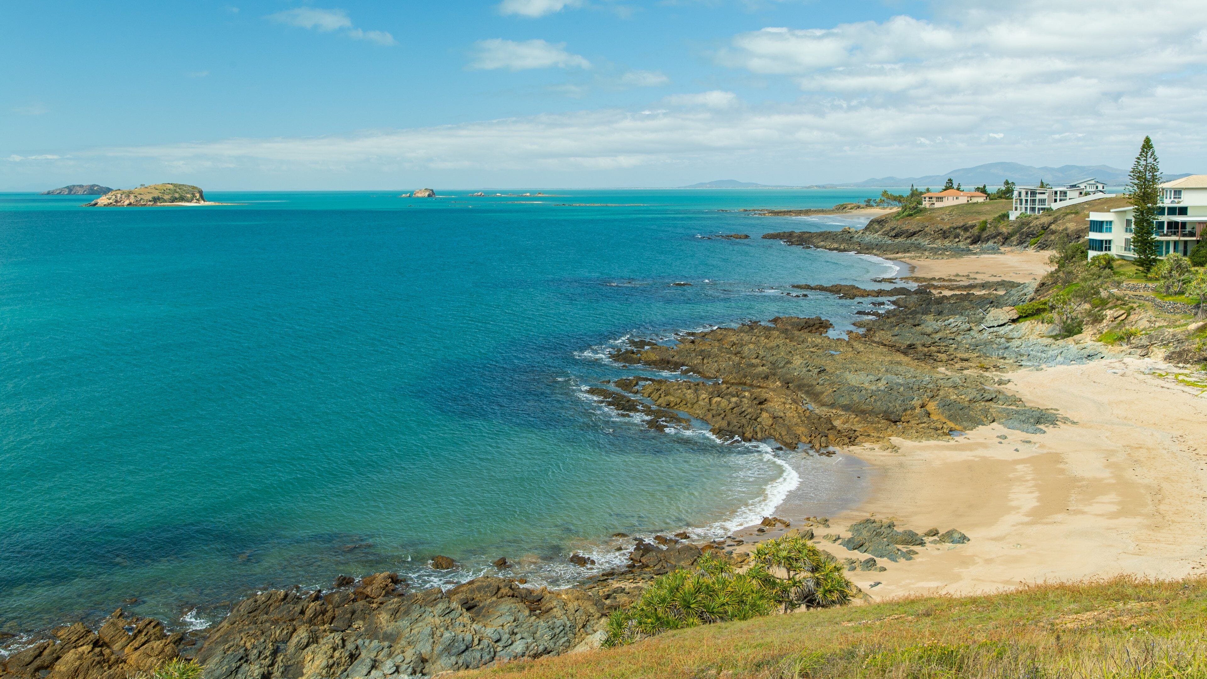 Emu Park showing landscape views, a beach and rocky coastline