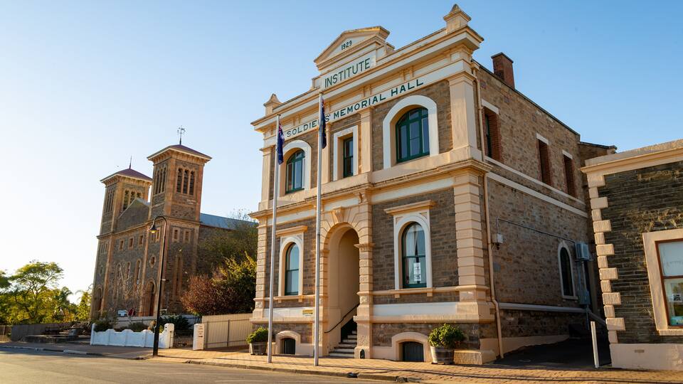 A historic building with a sign reading "Soldiers' Memorial Hall" and a tower.