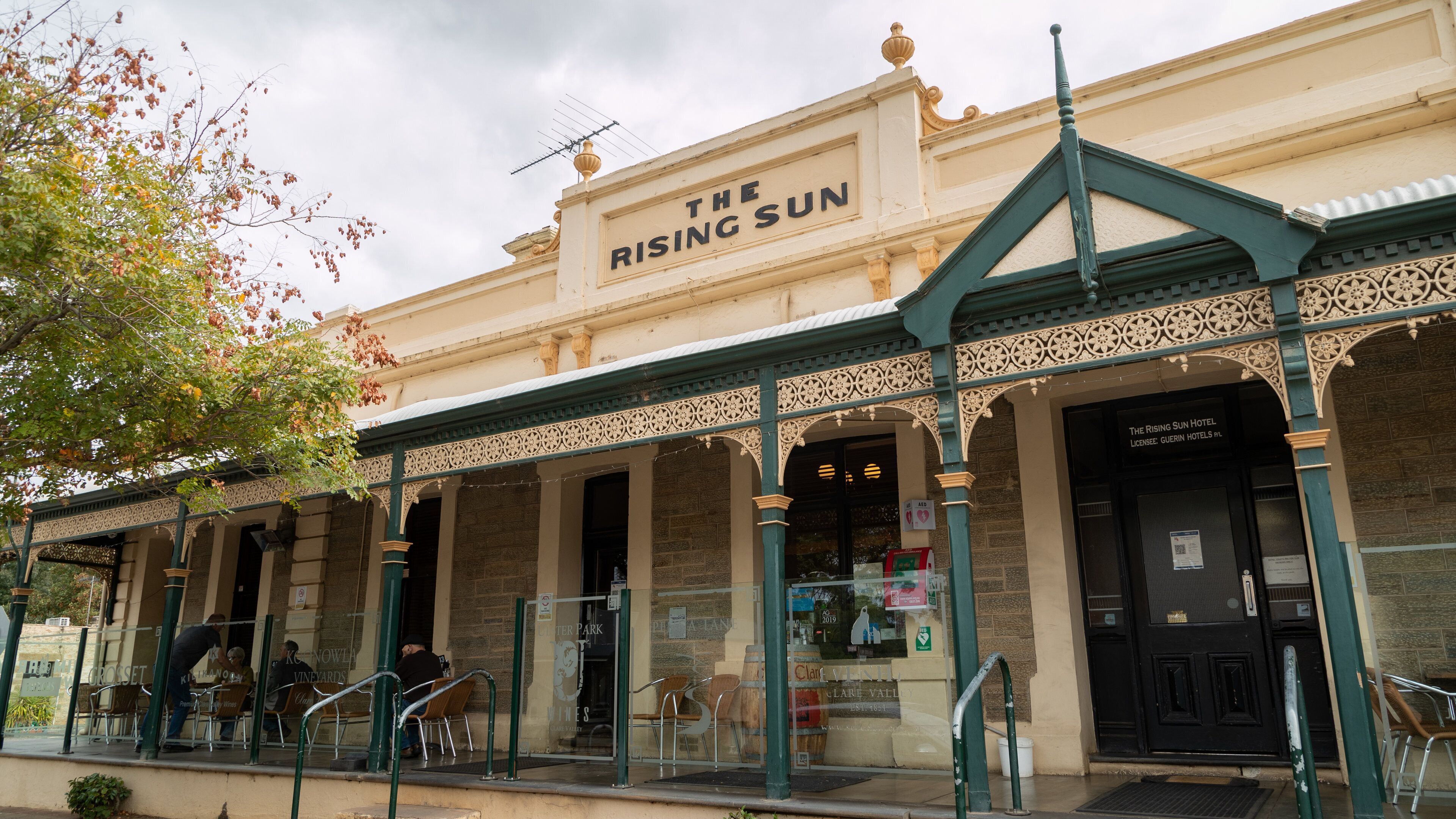 The Rising Sun Hotel with ornate architecture and outdoor seating.