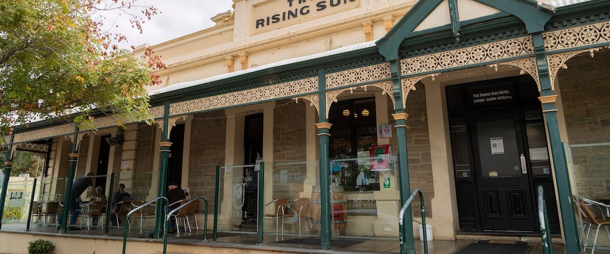 The Rising Sun Hotel with ornate architecture and outdoor seating.