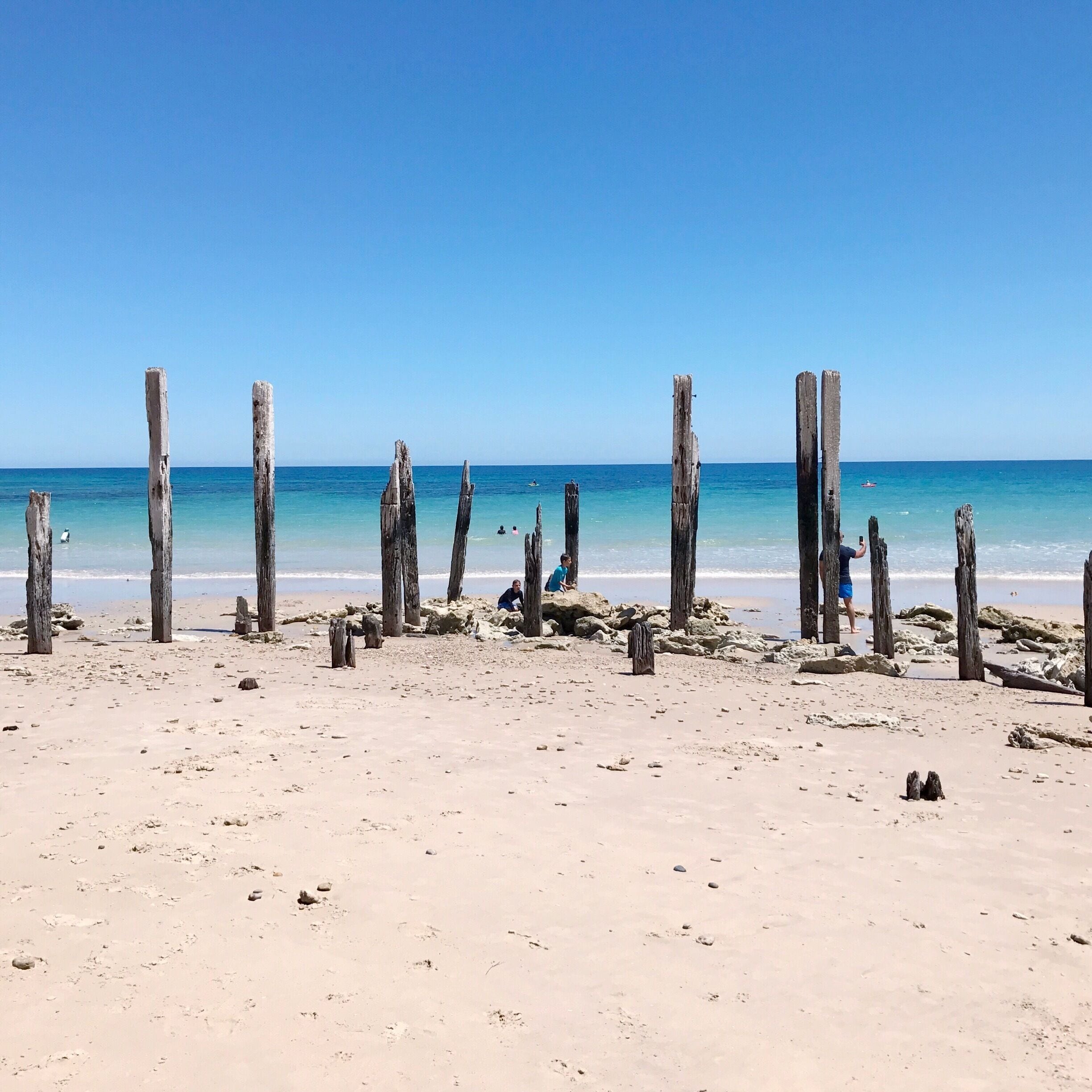 This is just one of the many stunning beaches in South Australia. I love the contrast between the white sand of the beach  and the rich #blue of the sea. The wooden piles are the ruins of a jetty and are now a favourite playground for kids. #LifeAtExpedia
