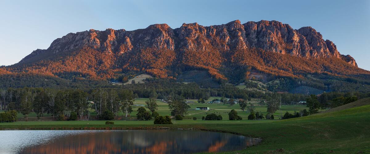 A mountain range with a lake in the foreground.