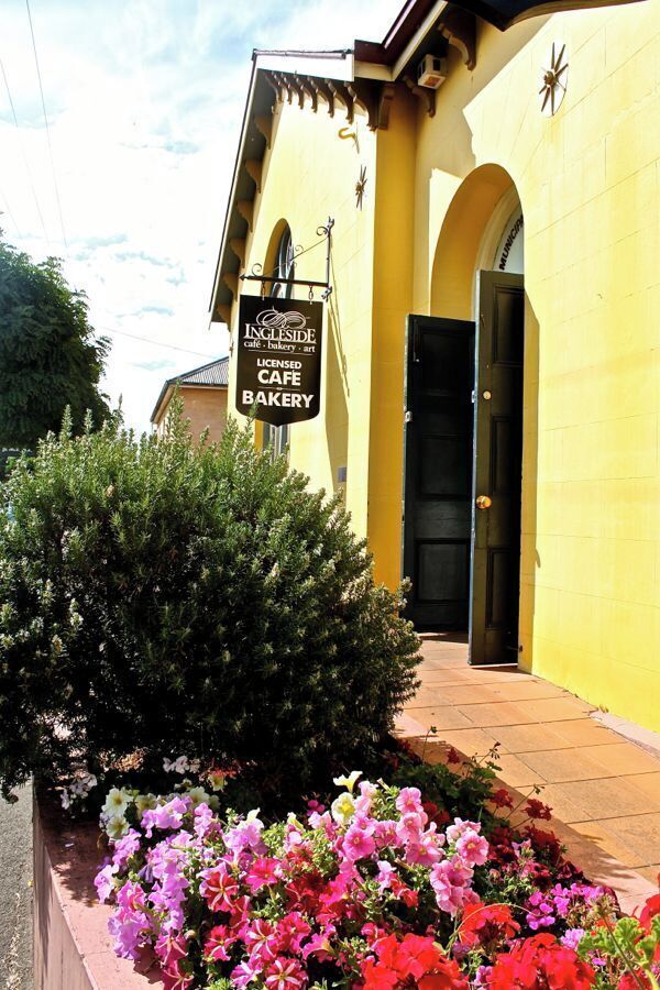 A yellow building with a sign for Ingleside Cafe & Bakery.