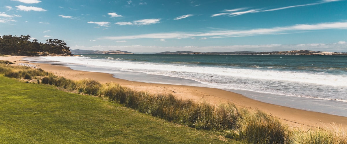 Bllackmans Bay beach in southern Hobart in Tasmania, Australia on a very windy day with intense swell and waves and no people