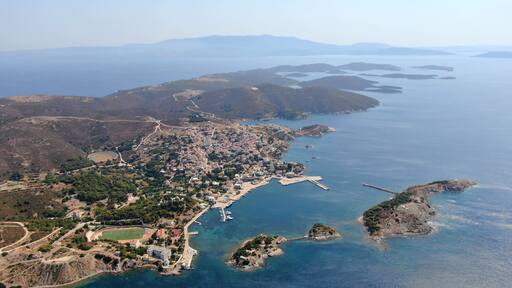 Aerial drone view of the Oinousses island complex east of Chios, Greece. Crystal-clear Aegean waters, scattered islets, rugged coastline and iconic maritime scenery. High-resolution Mediterranean land