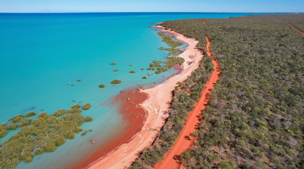 Aerial view of red sand beach and turquoise water in Roebuck Bay, Kimberley Region, Australia.