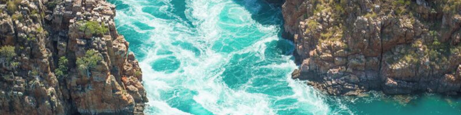 The Horizontal Falls in The Kimberley region of Western Australia are a natural phenomena. They’re created by two narrow openings between two escarpments. The tides in this region are some of the biggest in the world and can reach a difference of up to 12 metres.
As the tides change from low to high (and vice versa) they are sending an immense amount of water from one bay to another. The build up of that water forms a drop of up to four metres, hence creating a horizontal waterfall. More pics here: http://www.ytravelblog.com/horizontal-falls-tour/